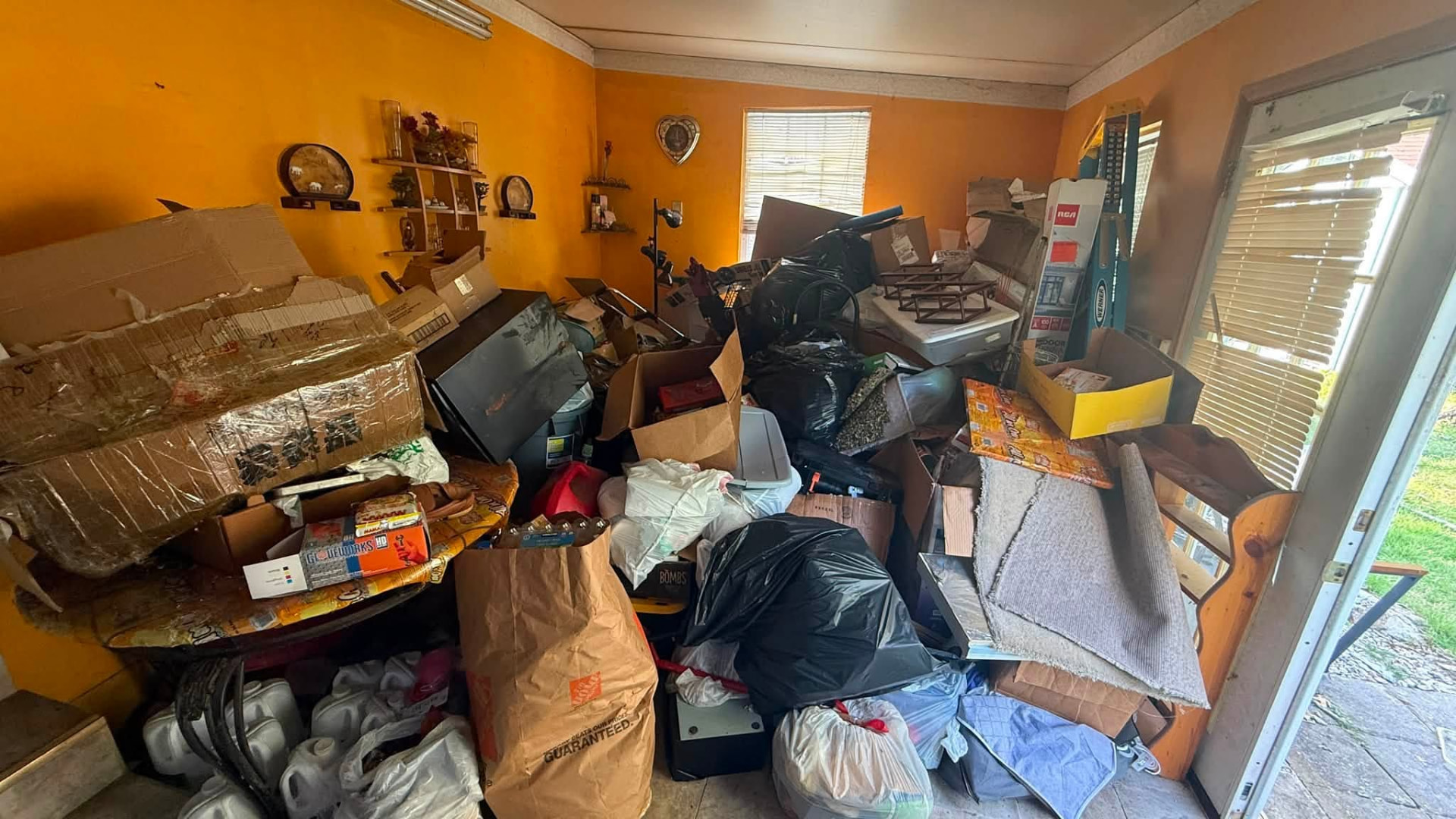 Room full of furniture and junk cleared by Haul It All Cincy